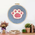 Finished dog paw print artwork displayed on a wall