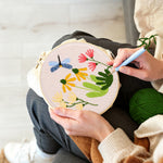 Creating handmade dragonfly and garden wildflowers punch needle artwork