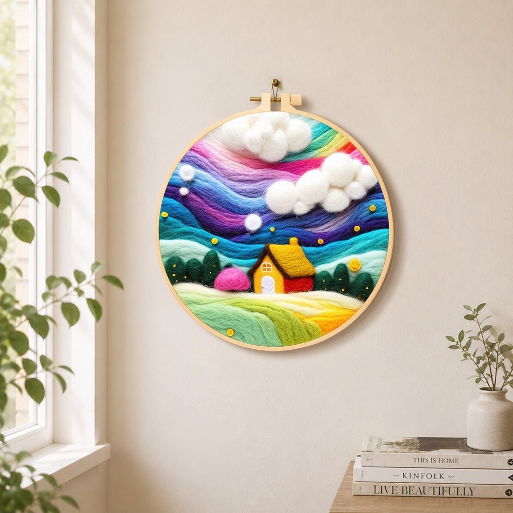 Dreamy cottage under the rainbow aurora needle felt wall art displayed in a bright home interior