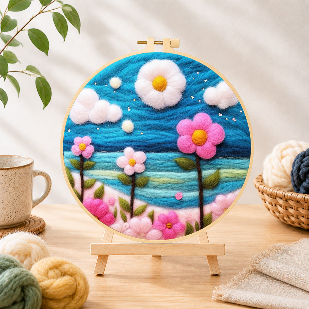 Finished dreamy pink flowers under the blue sky needle felting displayed on a wooden easel