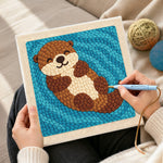 Creating handmade dreamy swimming otter punch needle artwork