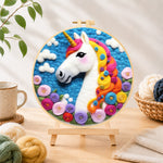 Finished dreamy unicorn and flowers needle felting displayed on a wooden easel