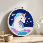 Dreamy unicorn on clouds punch needle artwork displayed on a table