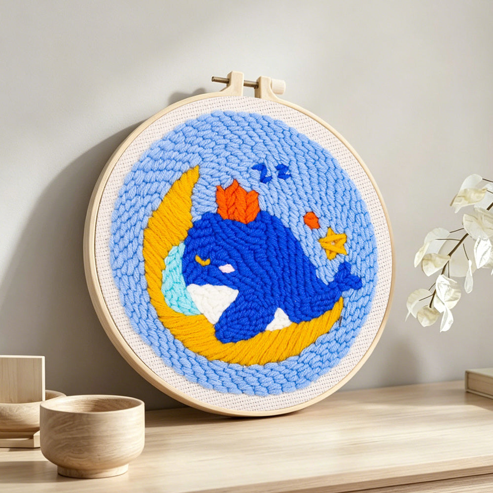 Dreamy whale and moon punch needle artwork displayed on a table