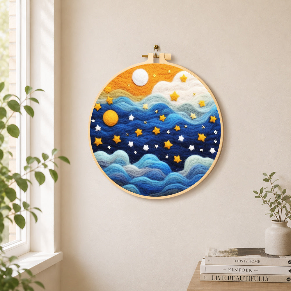 Drifting blue clouds and yellow stars needle felt wall art displayed in a bright home interior