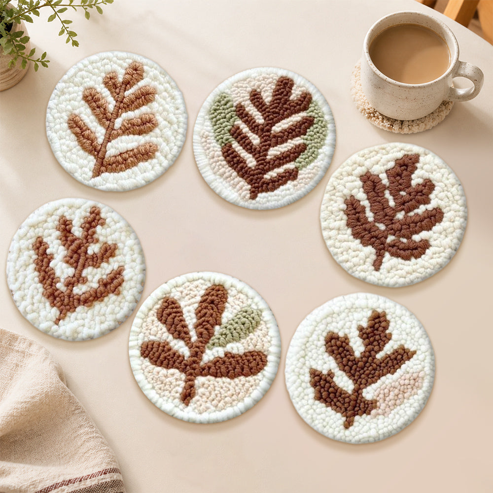 Earth-toned leaves punch needle coasters used for home decoration