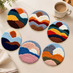 Earth-toned sun and mountains punch needle coasters used for home decoration