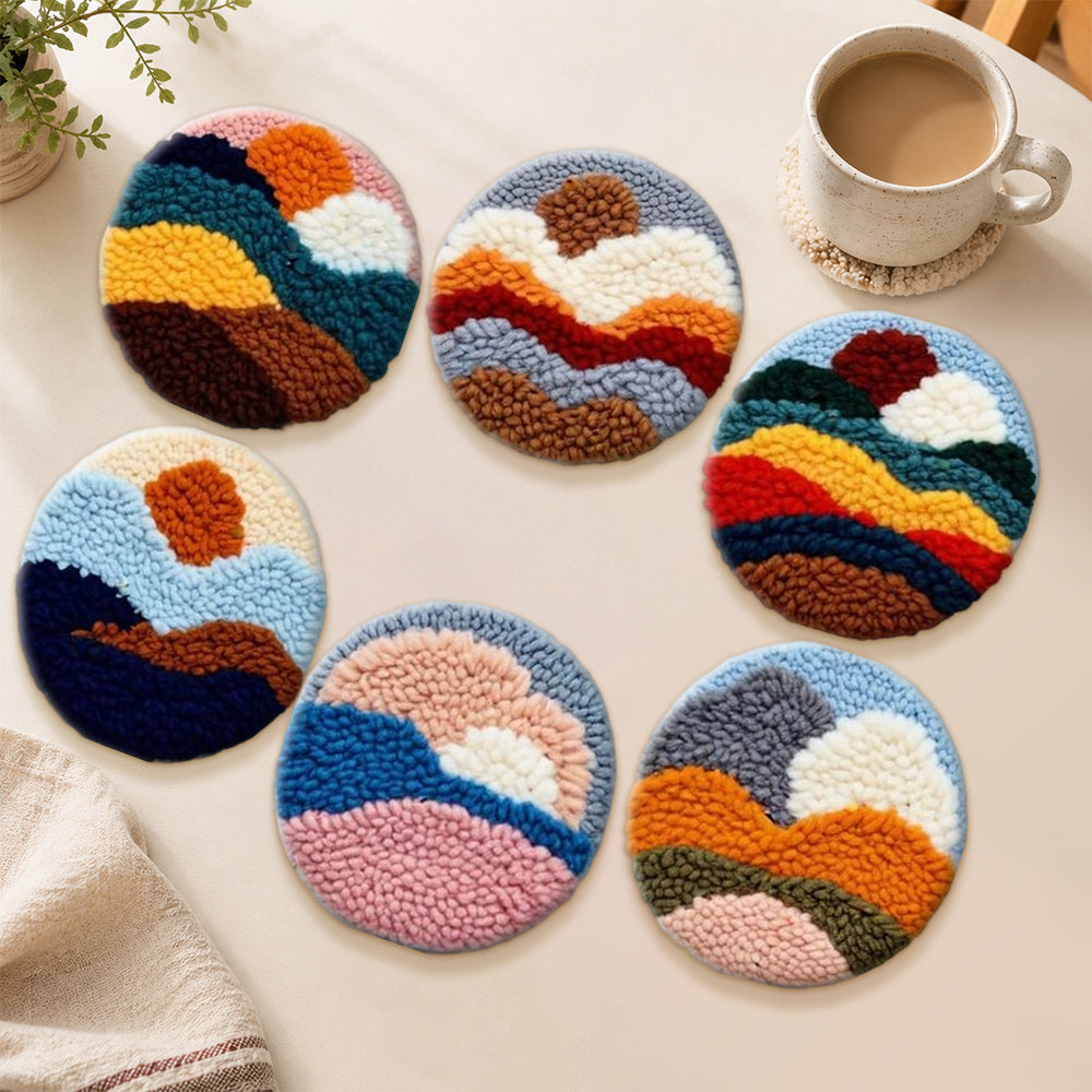Earth-toned sun and mountains punch needle coasters used for home decoration