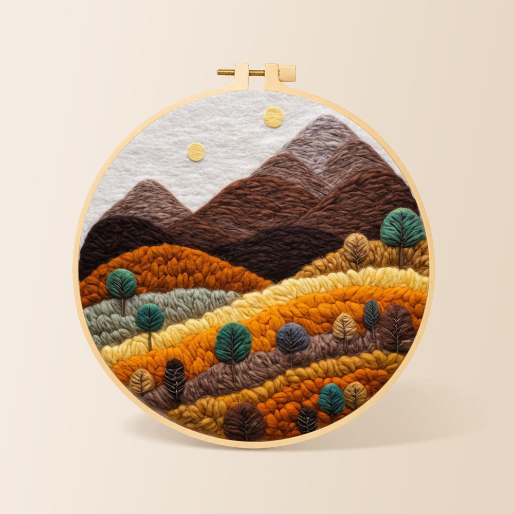 Earthy brown and burnt orange mountains with trees needle felting kit for beginners with a round wooden frame