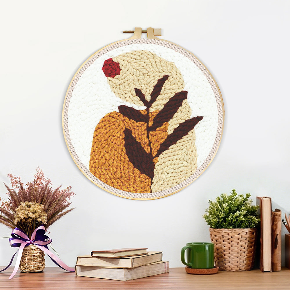 Finished earthy tones botanical leaf artwork displayed on a wall
