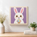 Finished easter bunny with egg basket artwork displayed on a wall