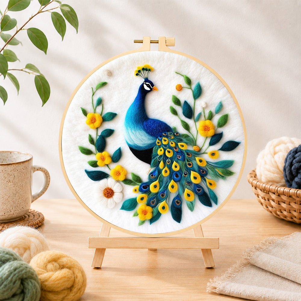 Finished elegant blue peacock needle felting displayed on a wooden easel
