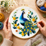 Creating the elegant blue peacock wool painting by hand with a felting needle