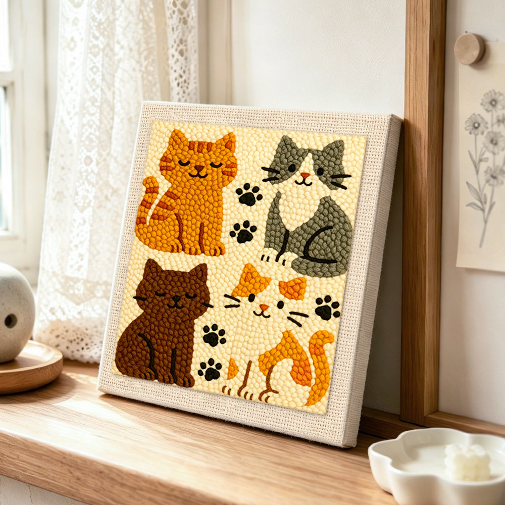 Elegant four cats and paw prints punch needle artwork displayed on a table