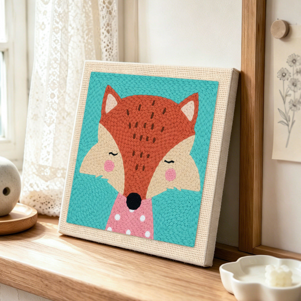 Elegant fox with pink polka dot collar punch needle artwork displayed on a table