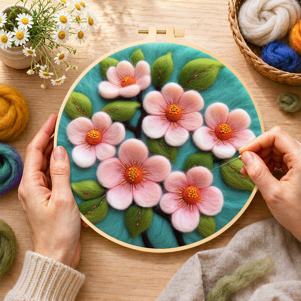 Creating the elegant pink flowers wool painting by hand with a felting needle
