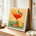 Elegant red cocktail punch needle artwork displayed on a table