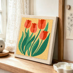 Elegant red tulips punch needle artwork displayed on a table