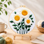 Finished elegant white daisies with yellow stamens needle felting displayed on a wooden easel