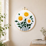 Elegant white daisies with yellow stamens needle felt wall art displayed in a bright home interior