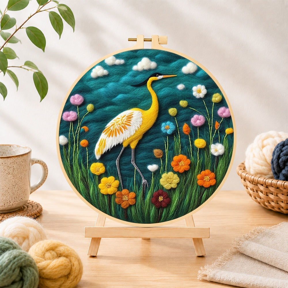 Finished elegant yellow heron among flowers needle felting displayed on a wooden easel