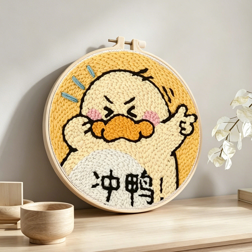 Encouraging cartoon duck punch needle artwork displayed on a table