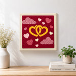 Finished entwined yellow hearts artwork displayed on a wall