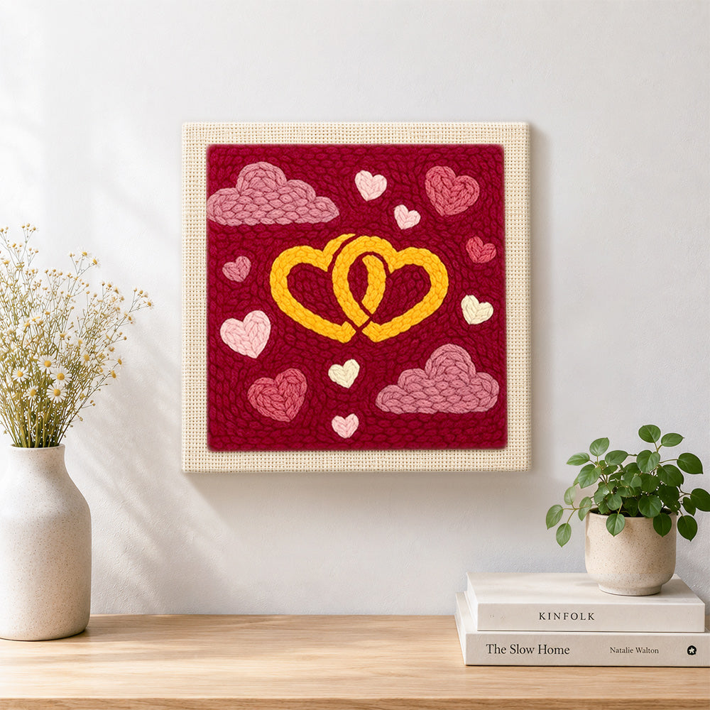 Finished entwined yellow hearts artwork displayed on a wall