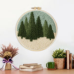 Finished evergreen forest artwork displayed on a wall