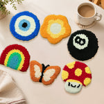 Evil eye, butterfly and rainbow punch needle coasters used for home decoration
