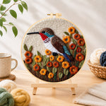 Finished exquisite hummingbird with autumn flowers needle felting displayed on a wooden easel