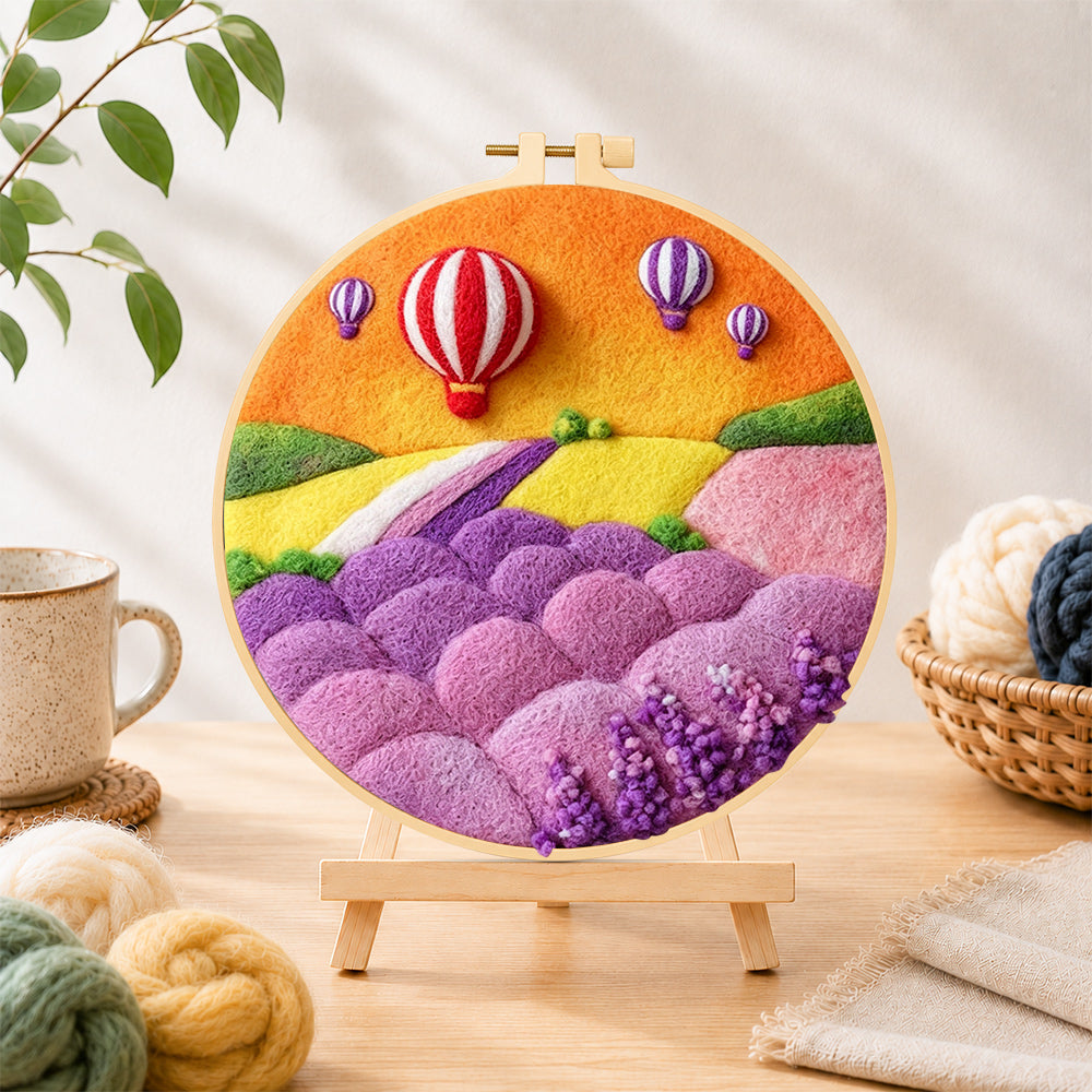 Finished fantasy hot air balloon tour and pastel hills needle felting displayed on a wooden easel