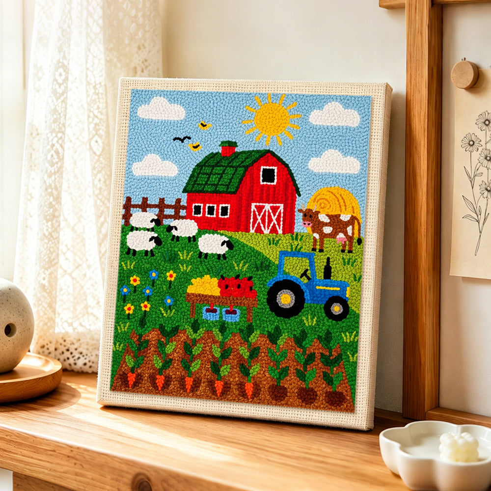 Farmyard animals and carrot field punch needle artwork displayed on a table