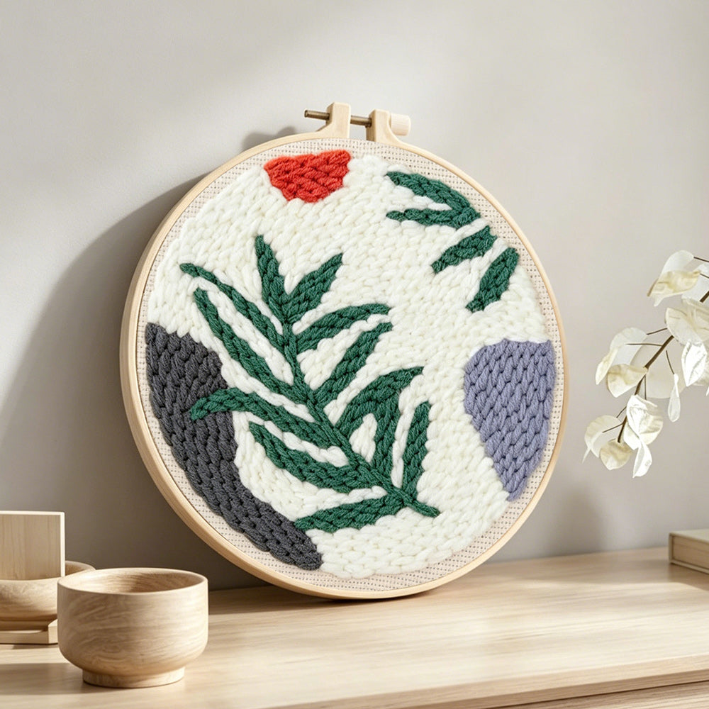 Fern leaf punch needle artwork displayed on a table