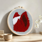 Fiery red fox punch needle artwork displayed on a table
