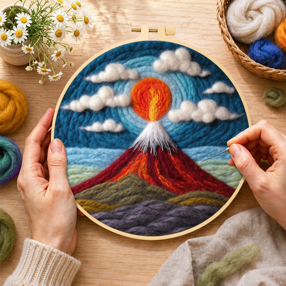 Creating the fiery red volcano under the swirling sky wool painting by hand with a felting needle