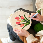 Creating handmade five coral tulips in bloom punch needle artwork