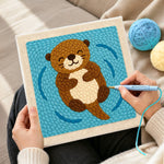 Creating handmade floating happy otter punch needle artwork