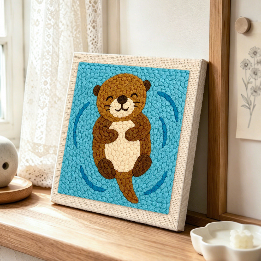 Floating happy otter punch needle artwork displayed on a table