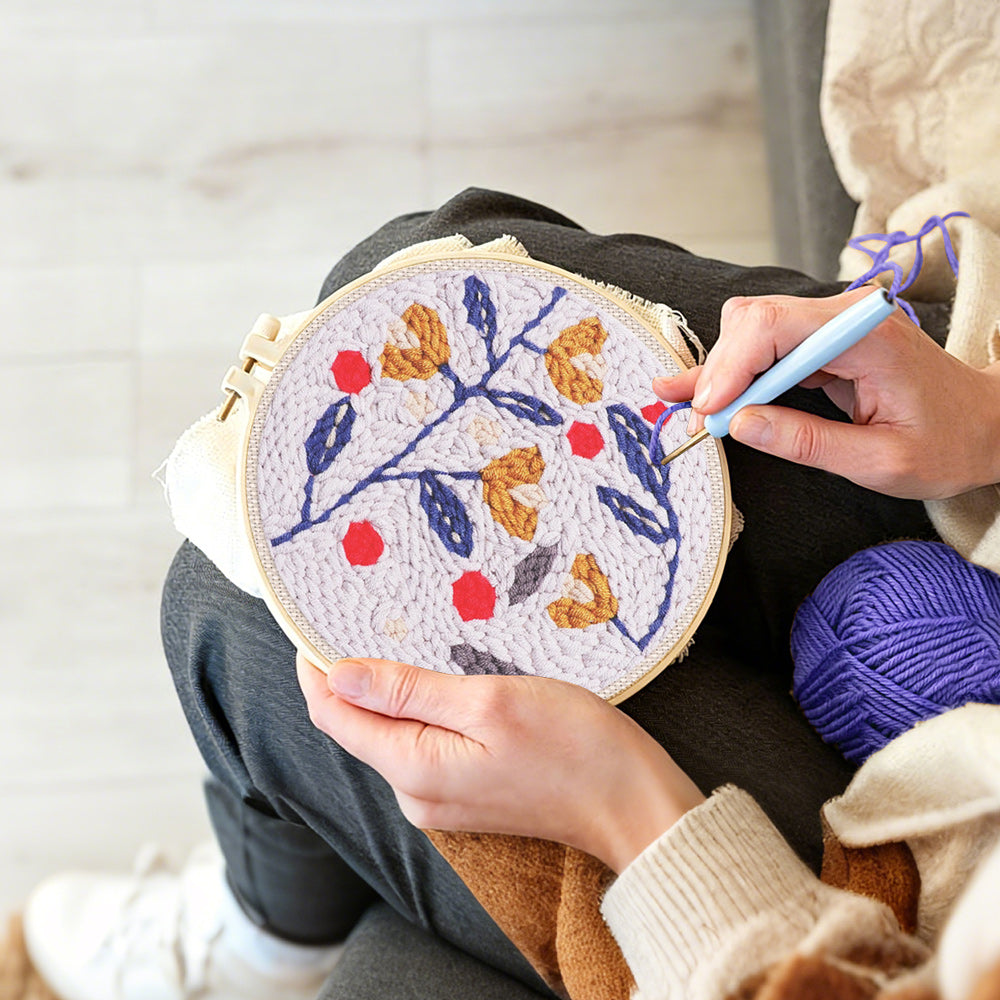 Creating handmade floral branch with red berries punch needle artwork