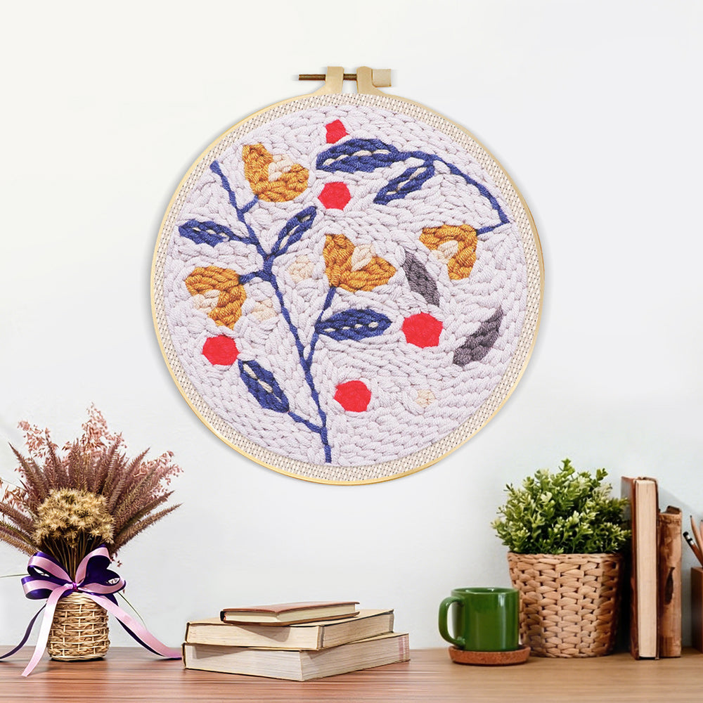 Finished floral branch with red berries artwork displayed on a wall