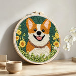 Floral corgi punch needle artwork displayed on a table