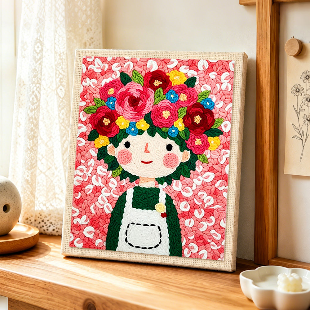 Floral crown girl and pink flowers punch needle artwork displayed on a table