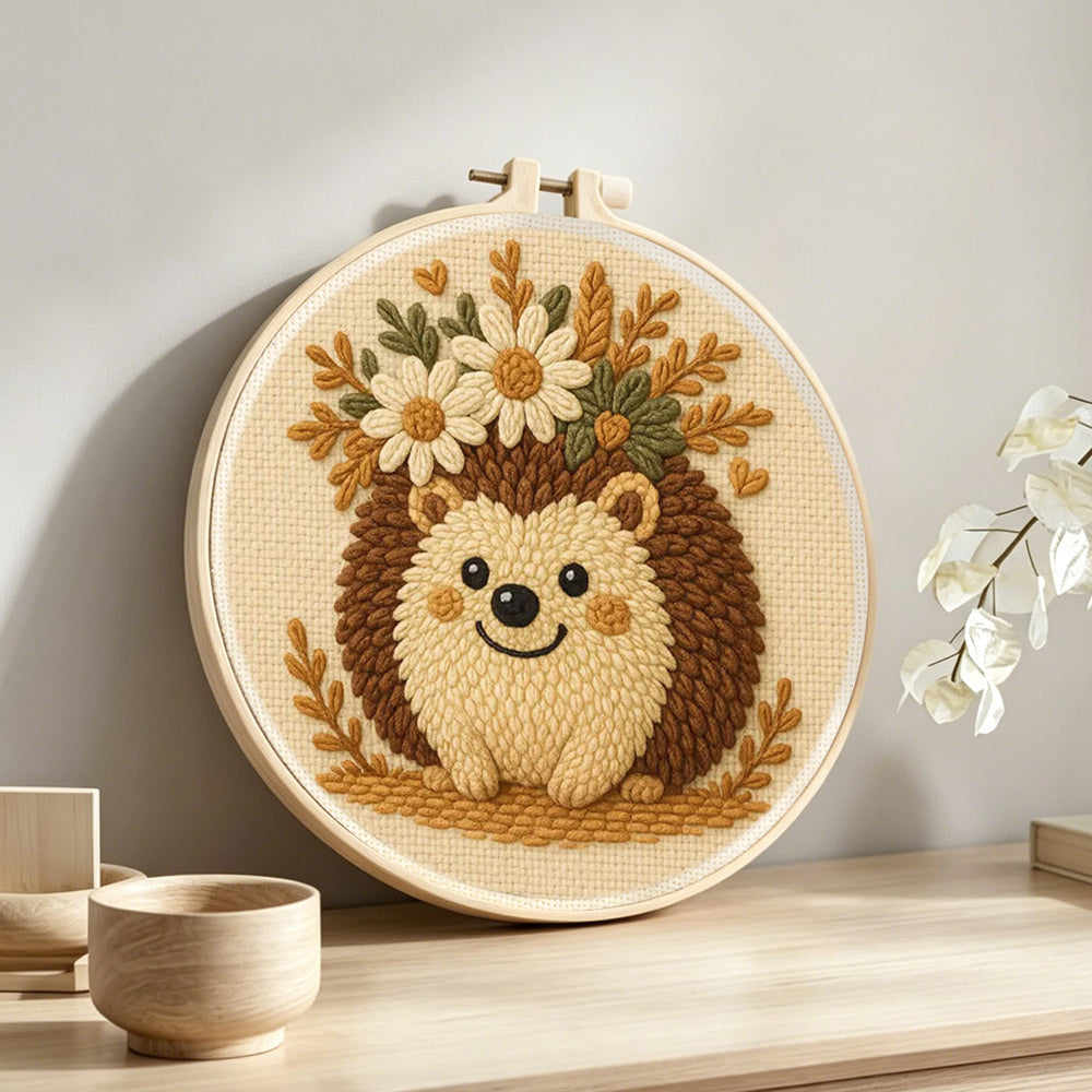 Floral crown hedgehog punch needle artwork displayed on a table