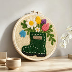 Floral green wellies boot vase punch needle artwork displayed on a table