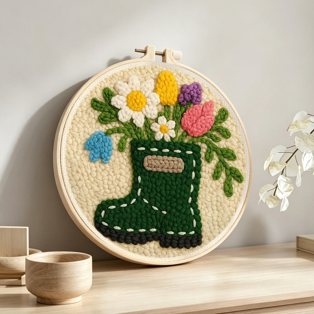 Floral green wellies boot vase punch needle artwork displayed on a table