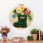Finished floral green wellies boot vase artwork displayed on a wall