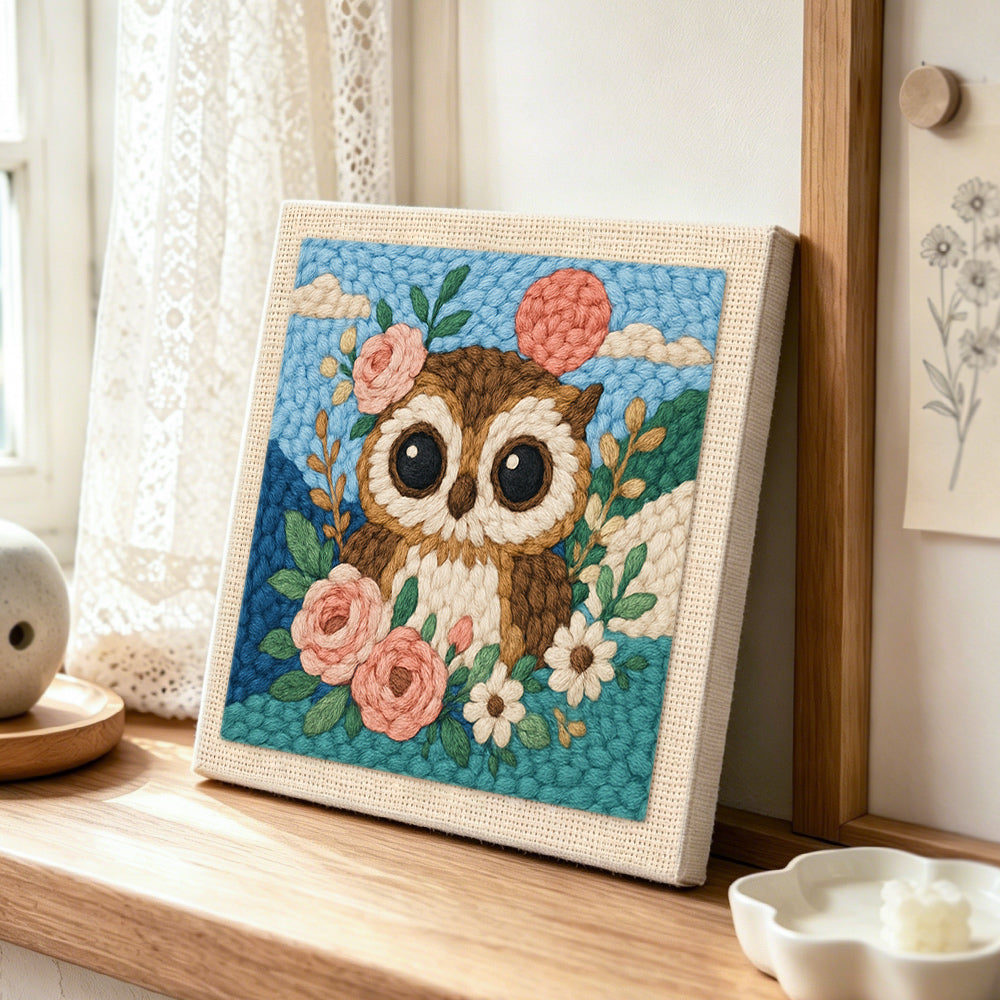 Floral owl with pink moon punch needle artwork displayed on a table
