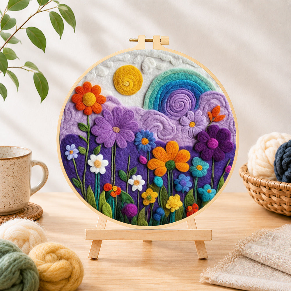 Finished flower field under the rainbow sky needle felting displayed on a wooden easel