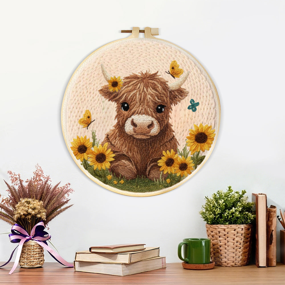 Finished fluffy brown highland cow and sunflowers artwork displayed on a wall